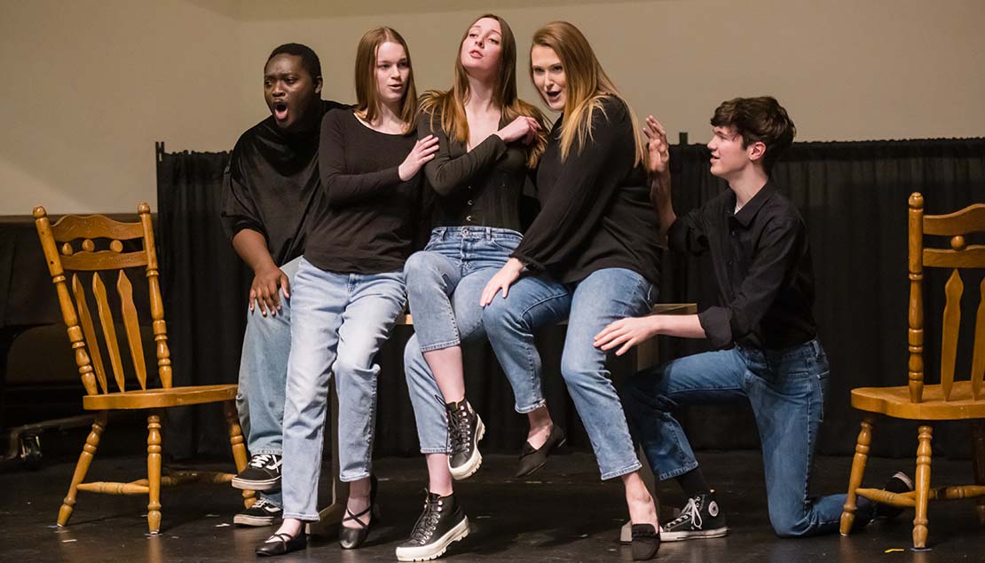 A group of students singing during a performance by Ӱҵ Opera Studio.