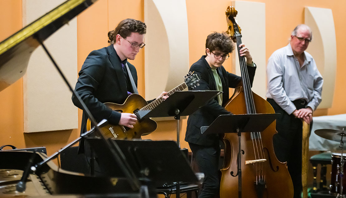 A group of students playing various instruments during a Ӱҵ Jazz Combo concert.