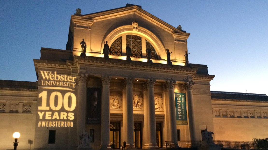 The Saint Louis Art Museum illuminated at night with "Ӱҵ 100 Years" shining on the building.