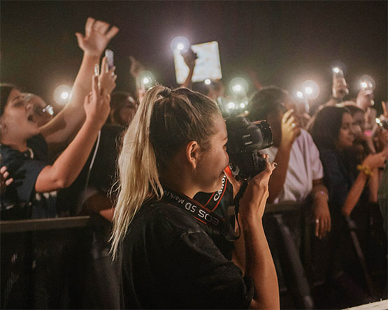 photographer taking picture in front of crowd