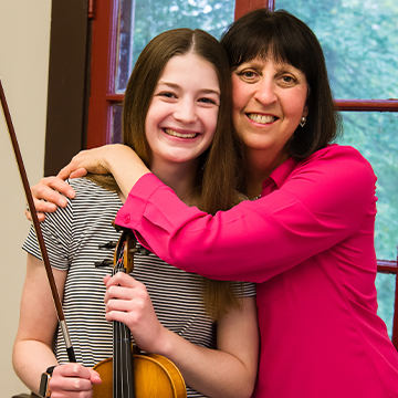 faculty with violin student photo