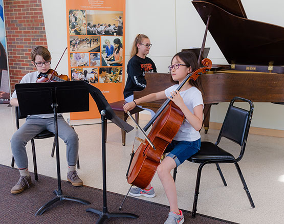 three youth musicians: cellist, violinist and pianist