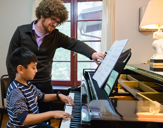 teacher with piano student
