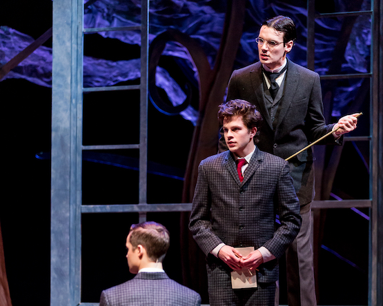Stage production of "Spring Awakening", featuring three actors.