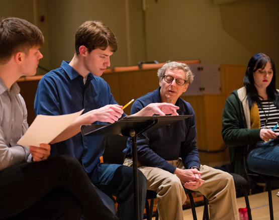 Students compose music during class with professor's guidance.