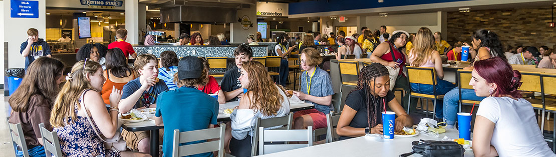 Students sitting at tables in the dining hall