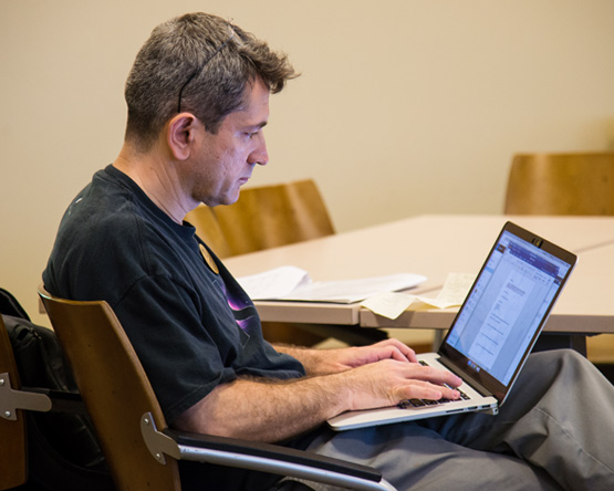 A man studies using his laptop.