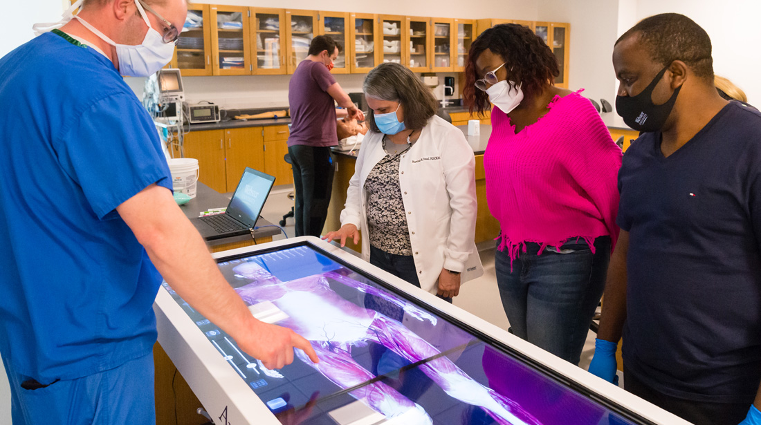 Students and professor explore state-of-the-art imaging equipment.