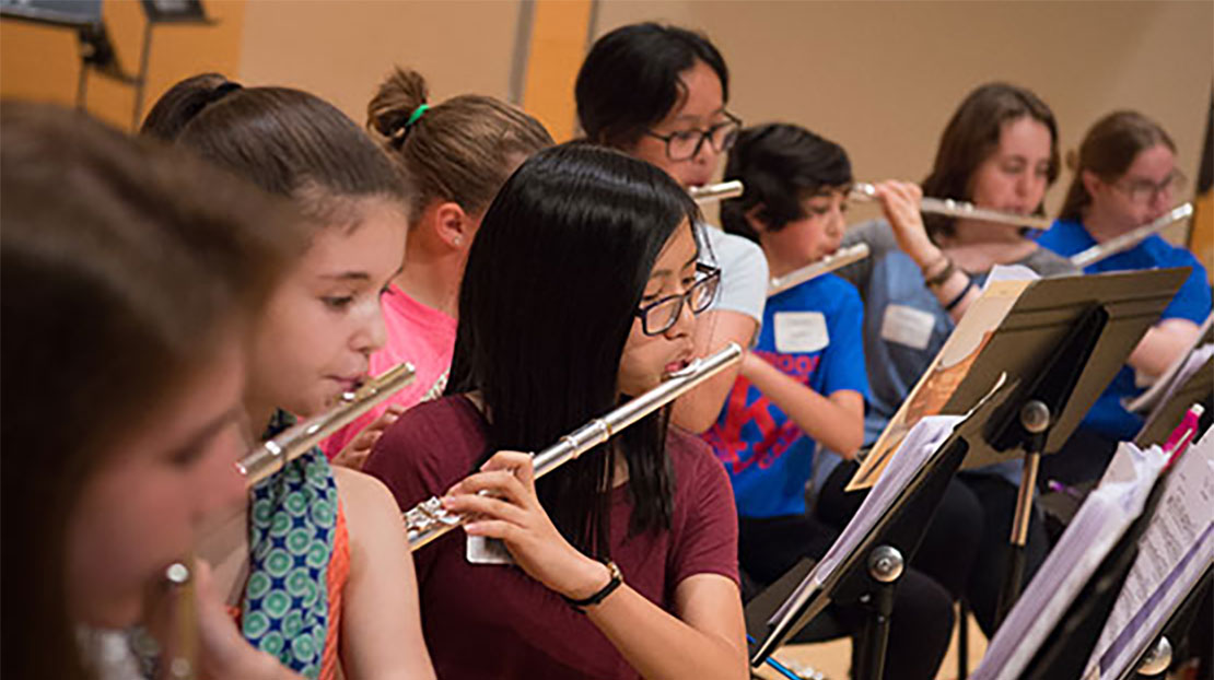 Students playing flutes.
